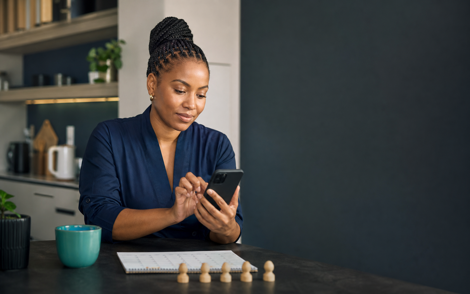 A member making a scheduled Stokvel deposit on a phone